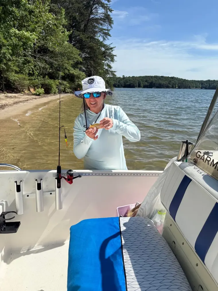 Founder of Aqua Marine Customs fishing from her center console boat on a South Carolina lake